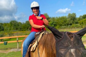 Nina from Endless Fridays on horseback during an adventure trip.