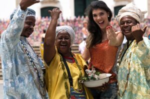 Woman traveler taking a photo with smiling locals